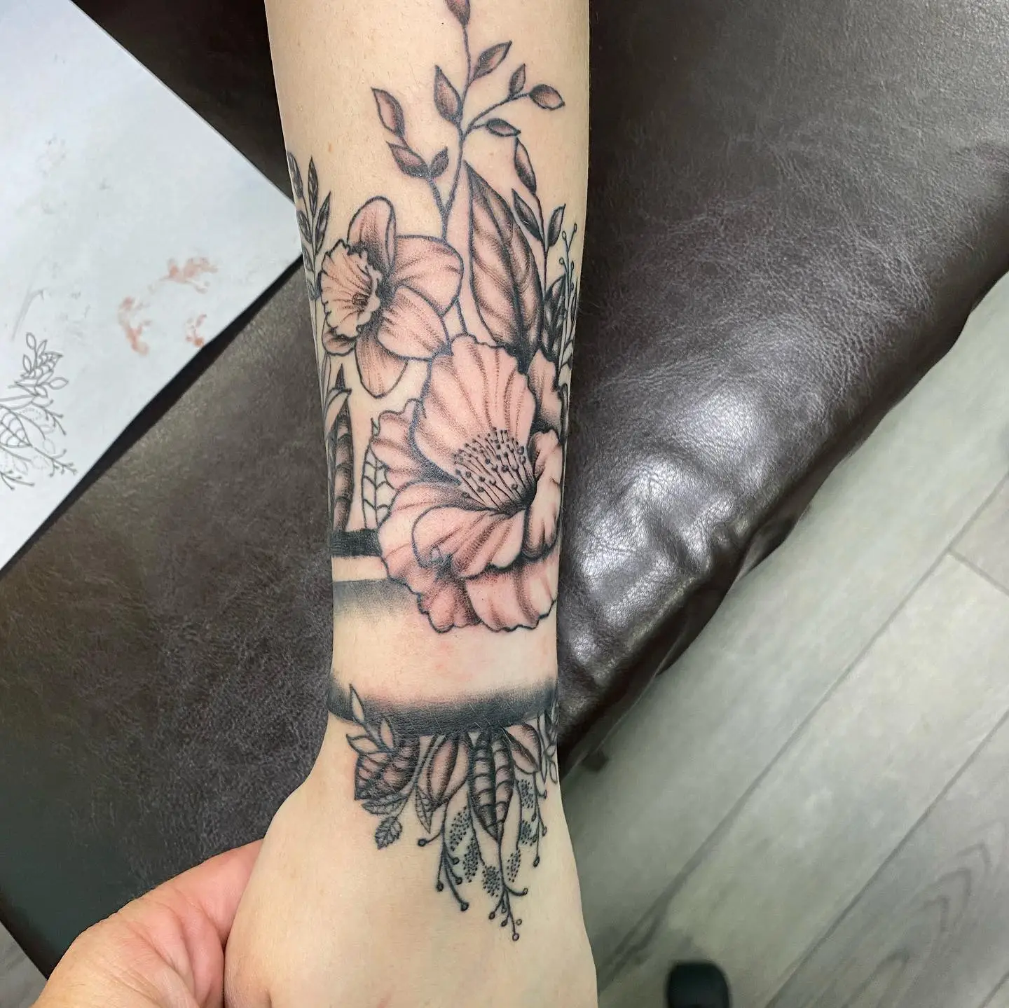 Tattoo of Flowers and vines on an arm.