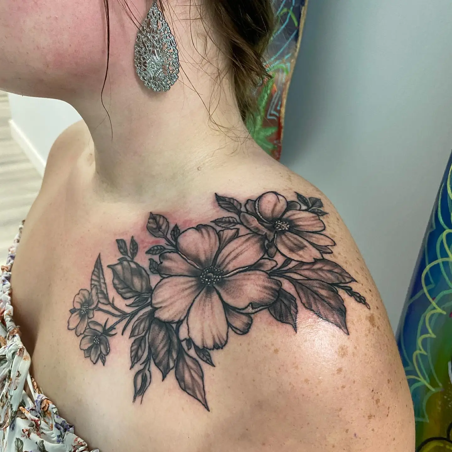 Tattoo on shoulder of a floral arrangement.