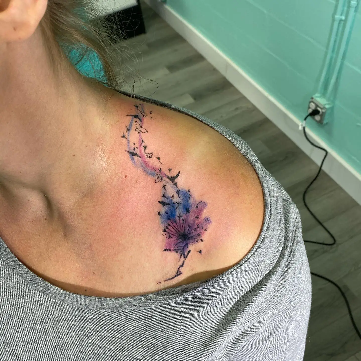 Abstract tattoo mimicking a floral pattern in water color.